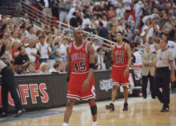 Chicago Bulls guard Michael Jordan (45) and forward Scottie Pippen (33) walk back to the bench during a timeout with 1.5 seconds left and the Orlando Magic leading 94-91 during their first playoff game in Orlando, May 7, 1995. The Magic won by the same score. Photo credit: Robert Baker, The Associated Press