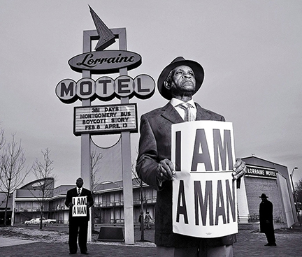 Elmore Nickleberry in 2008 holding a replica of a sign from the 1968 sanitation workers’ strike outside the Lorraine Motel in Memphis, where the Rev. Dr. Martin Luther King Jr. was assassinated. Photo credit: Carl Juste