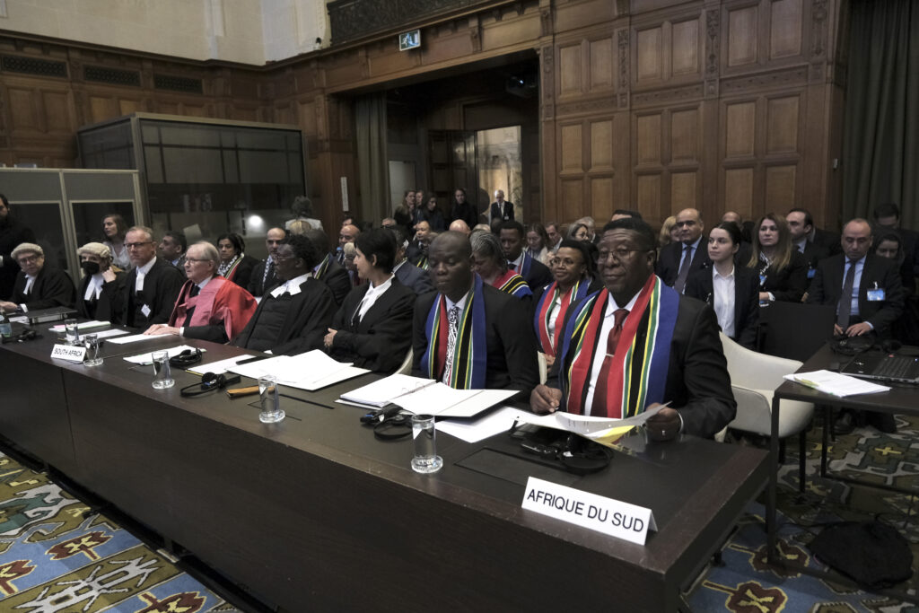 Vusimuzi Madonsela, ambassador of the Republic of South Africa to the Netherlands, front right, and Ronald Lamola, South Africa minister of justice and correctional services, front second right, during the opening of the hearings at the International Court of Justice in The Hague, Netherlands, Thursday, Jan. 11, 2024. The United Nations' top court opened hearings Thursday into South Africa's allegation that Israel's war with Hamas amounts to genocide against Palestinians, a claim that Israel strongly denies. Photo credit: Patrick Post, The Associated Press