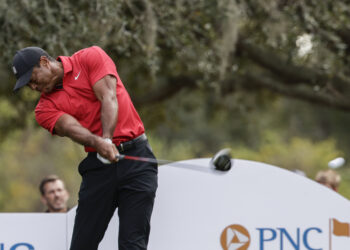 Tiger Woods tees off on the 13th hole during the final round of the PNC Championship golf tournament, Sunday, Dec. 17, 2023, in Orlando, Florida. Photo credit: Kevin Kolczynski, The Associated Press