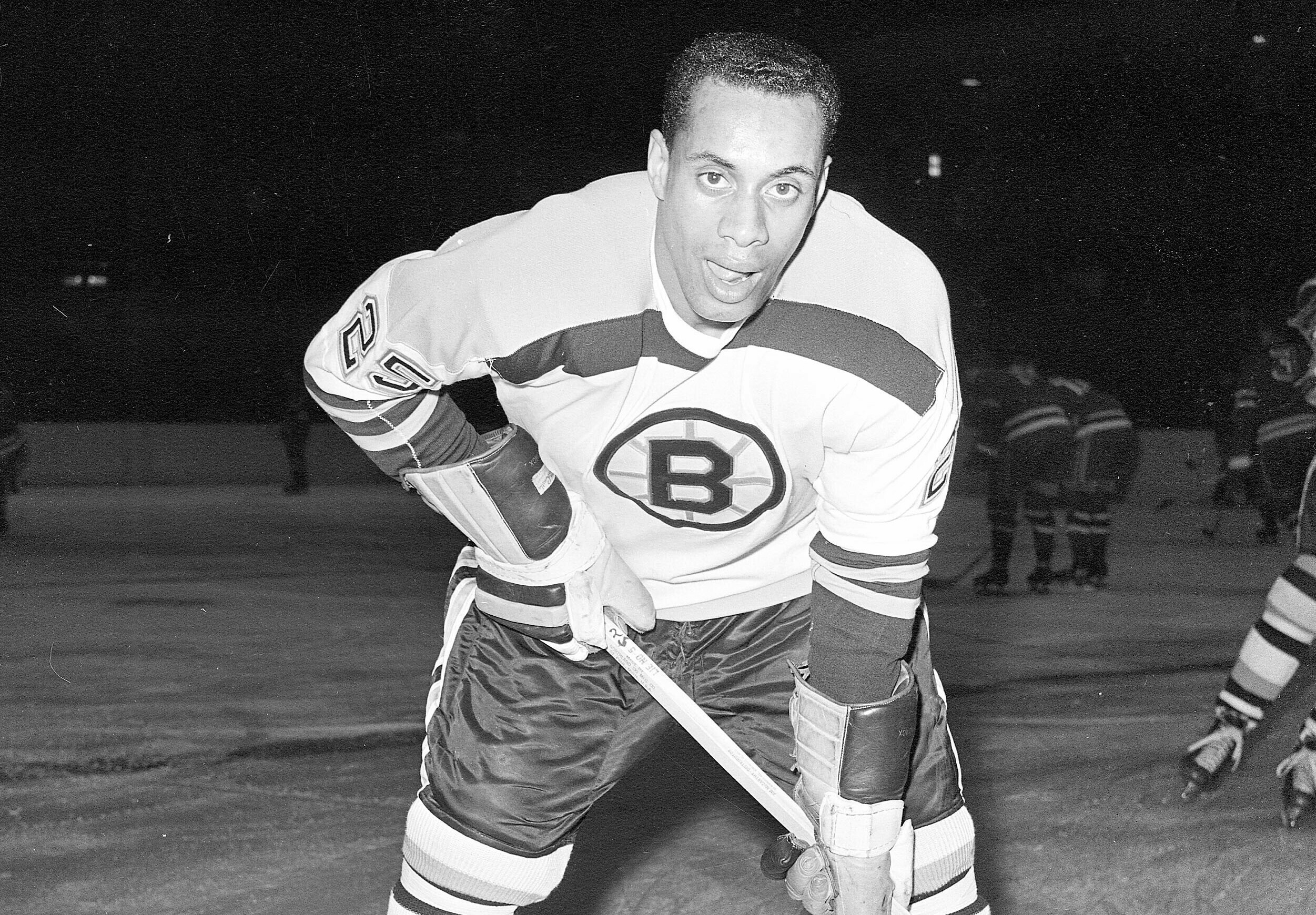 In this November 23, 1960, file photo, 25-year-old left wing Willie O'Ree, the first Black player of the National Hockey League, warms up in his Boston Bruins uniform, prior to the game with the New York Rangers, at New York's Madison Square Garden. Photo credit: The Associated Press
