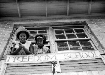Two girls look out the window of a Freedom School. Photo credit: Ken Thompson, United Methodist Board of Global Ministries