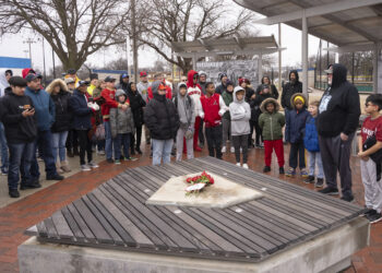 A group of people gathered at the Jackie Robinson pavilion at McAdams Park in Wichita, Kansas, on Saturday, Jan. 27, 2024. A bronze statue of baseball legend Jackie Robinson was cut down and stolen from this spot on Thursday, Jan. 25, 2024, where a youth baseball league plays. At far right is League 42 Director Bob Lutz addressing the crowd. The statue is valued at $75,000. Photo credit: Jaime Green, The Wichita Eagle via The Associated Press