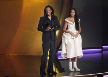 Jay-Z, left, accepts the Dr. Dre Global Impact Award as daughter, Blue Ivy Carter, looks on during the 66th annual Grammy Awards on Sunday, Feb. 4, 2024, in Los Angeles. Photo credit: Chris Pizzello, The Associated Press