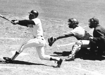 Willie Mays, center field slugger of the San Francisco Giants, connects with the 3,000th hit of his career a single to left-in second inning against Montreal on July 18, 1970, at Candlestick Park in San Francisco. Expos catcher John Bateman waits for pitch from teammate Mike Wegener. It never arrived. Umpire is Mel Steiner. Mays received the ball immediately at ceremony on the field. Photo credit: The Associated Press
