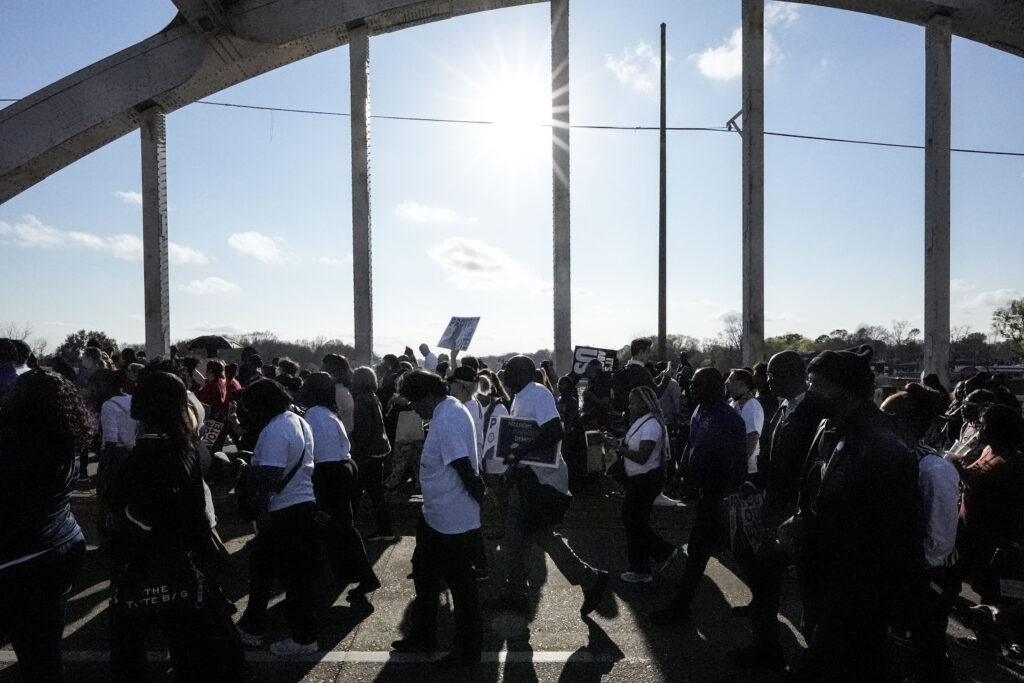 Hundreds of people walk across the Edmund Pettus Bridge commemorating the 59th anniversary of the Bloody Sunday voting rights march in 1965, Sunday, March 3, 2024, in Selma, Alabama. Photo credit: Mike Stewart, The Associated Press