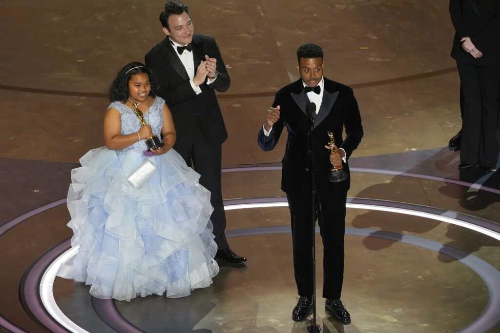 Porche Brinker, from left, Ben Proudfoot, and Kris Bowers accept the award for Best Documentary Short Film for "The Last Repair Shop" during the Oscars on Sunday, March 10, 2024, at the Dolby Theatre in Los Angeles. Photo credit: Chris Pizzello, The Associated Press