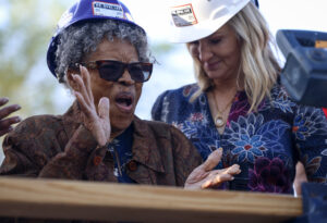 Opal Lee, left, applauds during a ceremony before raising the first wall to her new home on her family's former lot in Fort Worth, Texas, on Thursday, March 21, 2024. Lee, one of the driving forces behind Juneteenth becoming a national holiday, attended a ceremony to watch as the walls are raised on new home. In 1939, a racist mob drove her family out of their home. Photo credit: Amanda McCoy , Star-Telegram via The Associated Press