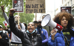 Protestors shout in Hyde Park during protests in London, Friday, June 12, 2020, in response to the May 25, 2020, murder of George Floyd by police officers in Minneapolis that led to protests in many countries and across the United States. Photo credit: Alberto Pezzali, The Associated Press