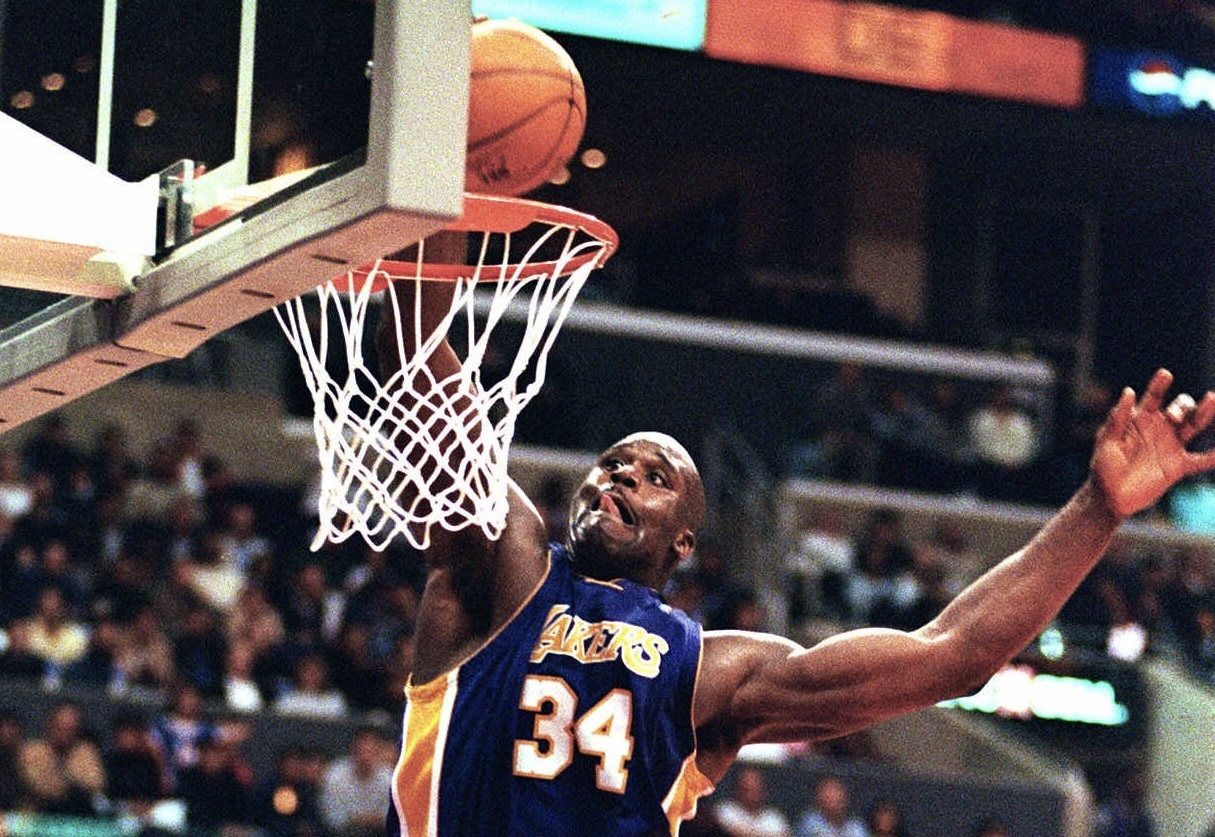 Then-Los Angeles Lakers center Shaquille O'Neal dunks the ball during the game against the Los Angeles Clippers Monday, March 6, 2000. In this season of campaigns, Shaquille O'Neal made a convincing pitch to MVP voters — a career-high 61 points. "It's a good feeling," O'Neal said after the Los Angeles Lakers beat the Clippers 123-103 for their 16th consecutive victory, equaling their longest winning streak of the season. Photo credit: E.J. Flynn, The Associated Press