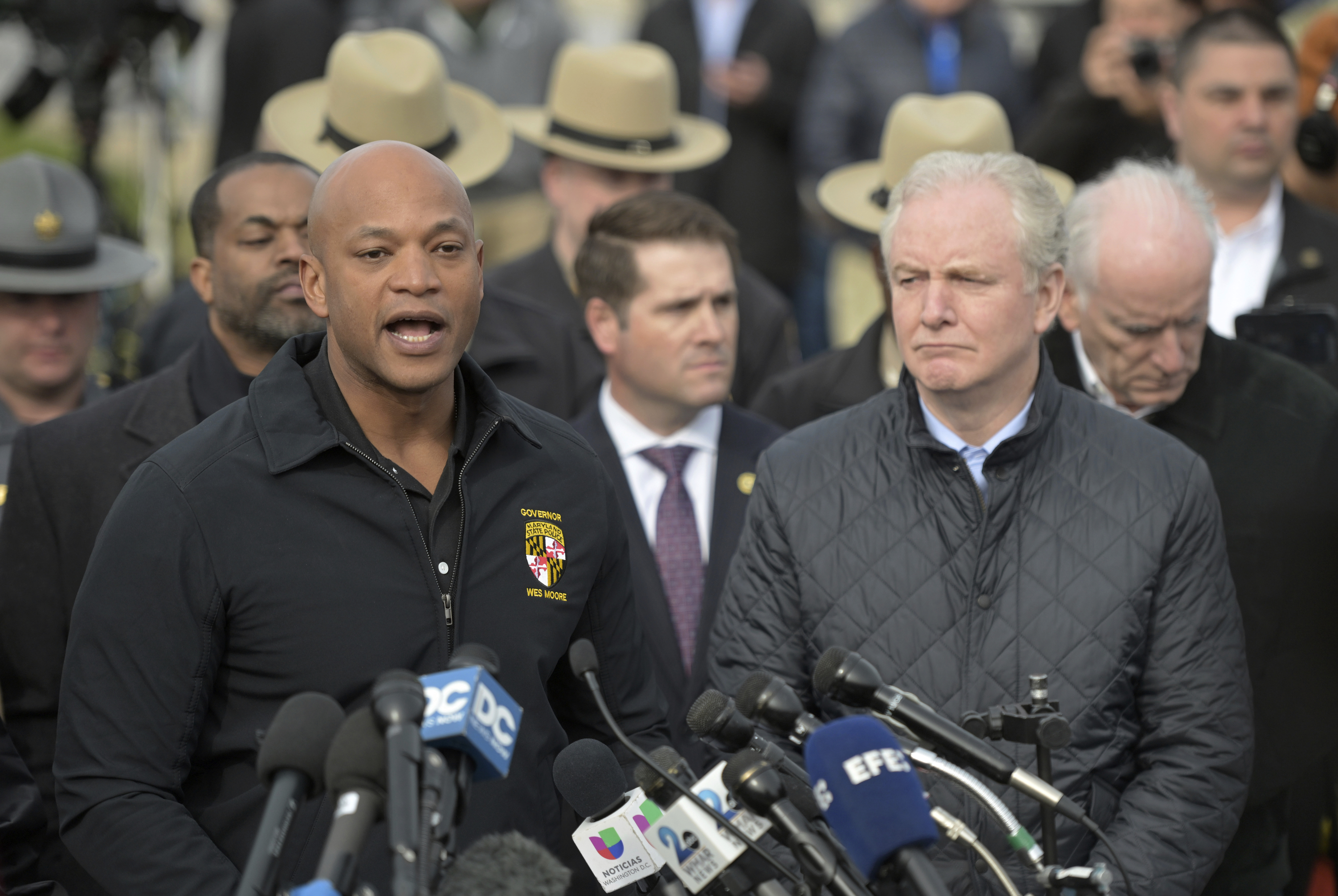 Maryland Gov. Wes Moore, left, speaks during a news conference as Sen. Chris Van Hollen (D-MD) looks on near the scene where a container ship collided with a support on the Francis Scott Key Bridge, Tuesday, March 26, 2024 in Baltimore. The major bridge in Baltimore snapped and collapsed after a container ship rammed into it early Tuesday, and several vehicles fell into the river below. Rescuers were searching for multiple people in the water. Photo credit: Steve Ruark, The Associated Press