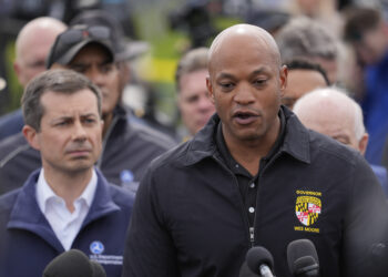 Maryland Gov. Wes Moore, accompanied by Transportation Secretary Pete Buttigieg and other officials, speaks during a news conference near the scene where a container ship collided with a support on the Francis Scott Key Bridge, in Dundalk, Maryland, Tuesday, March 26, 2024. Photo credit: Matt Rourke, The Associated Press