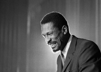 Bill Russell grins at the announcement that he was named coach of the Boston Celtics on April 18, 1966. The late Russell, then 32, a former University of San Francisco basketball star, became the first Black head coach in National Basketball Association history. Photo credit: The Associated Press