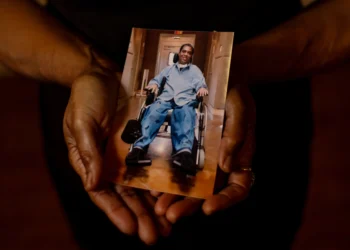Kentrell Parker, an inmate at the Louisiana State Penitentiary at Angola, in a photograph held by his mother, Janice Parker. The 45-year-old has been bedridden since an injury in a prison football game left him paralyzed from the neck down 14 years ago. Photo credit: Kathleen Flynn, special to ProPublica