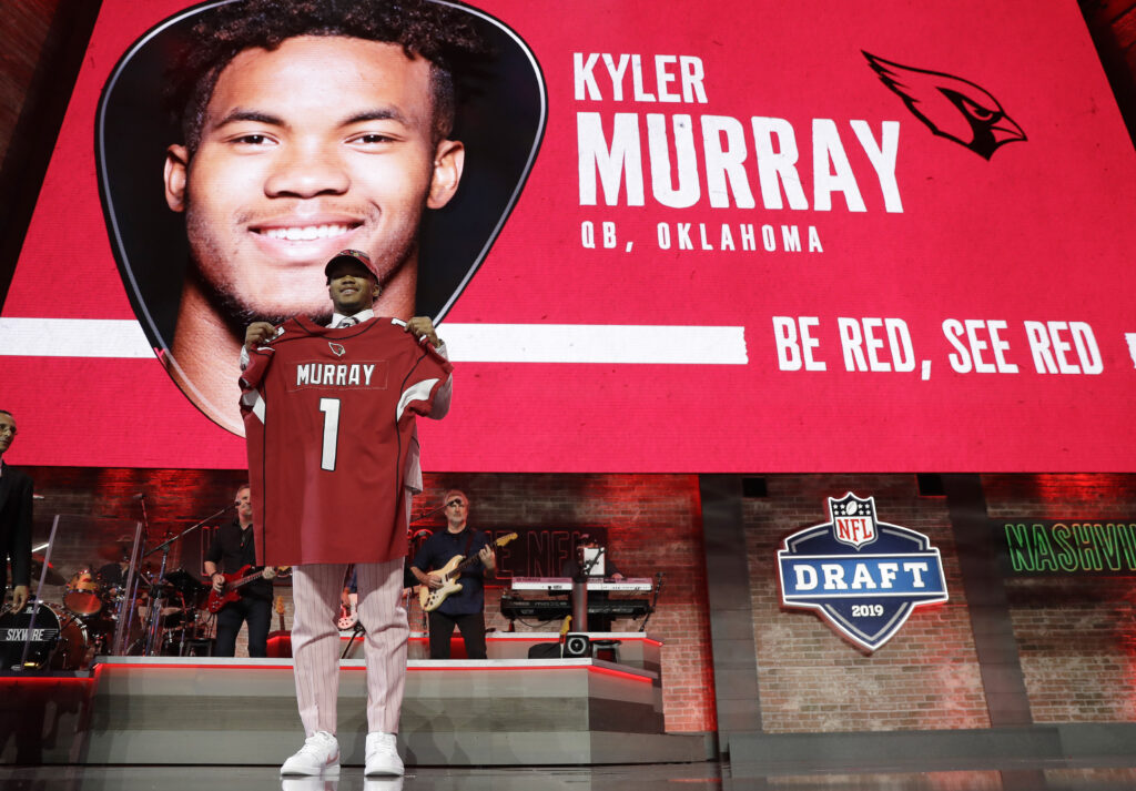 Oklahoma quarterback Kyler Murray shows off his new jersey after the Arizona Cardinals selected him in the first round at the NFL Draft on Thursday, April 25, 2019, in Nashville. Photo credit: Mark Humphrey, The Associated Press