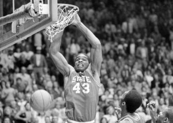 This April 4, 1983, file photo shows North Carolina State's Lorenzo Charles (43) dunking the ball against the University of Houston in the NCAA championship game in Albuquerque, New Mexico. Charles' dunk shot with one second remaining fulfilled North Carolina State's impossible dream, giving the Wolfpack a 54-52 victory over top-ranked Houston for the NCAA basketball championship. Photo credit: The Associated Press