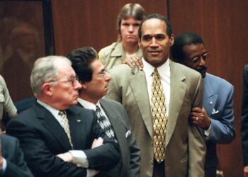 Late attorney Johnnie Cochran Jr. holds onto O.J. Simpson as a not guilty verdict is read in a Los Angeles courtroom on Oct. 3, 1995. Left is F. Lee Bailey and second from left is Robert Kardashian. Photo credit: Myung J. Chun, The Associated Press/pool