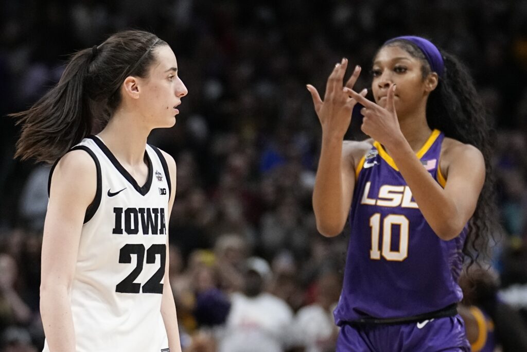 LSU's Angel Reese reacts in front of Iowa's Caitlin Clark during the second half of the NCAA Women's Final Four championship basketball game April 2, 2023, in Dallas. Iowa and LSU are getting ready to meet again in a rematch of the 2023 national championship game on Monday, April 1, 2024. Photo credit: Tony Gutierrez, The Associated Press