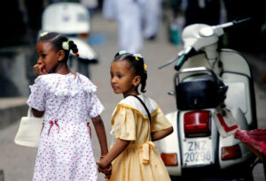 Tanzania is one of the countries in Africa where Swahili is commonly spoken. Here, Muslim girls, dressed for the Eid al-Fitr holiday, walk hand in hand through the narrow alleys of Stone Town, Zanzibar, in Tanzania, on Nov. 4, 2005. Photo credit: Karel Prinsloo, The Associated Press