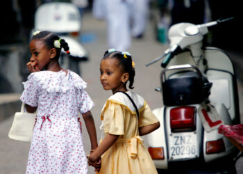 Tanzania is one of the countries in Africa where Swahili is commonly spoken. Here, Muslim girls, dressed for the Eid al-Fitr holiday, walk hand in hand through the narrow alleys of Stone Town, Zanzibar, in Tanzania, on Nov. 4, 2005. Photo credit: Karel Prinsloo, The Associated Press