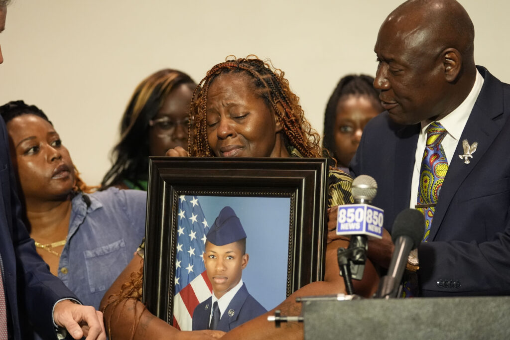 Chantemekki Fortson, mother of Roger Fortson, a U.S. Air Force airman, holds a photo of her son during a news conference regarding his death, along with family and attorney Ben Crump, Thursday, May 9, 2024, in Fort Walton Beach, Florida, Fortson was shot and killed by police in his apartment on on May 3, 2024. Photo credit: Gerald Herbert, The Associated Press
