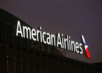 The American Airlines logo is stands atop the American Airlines Center, Dec. 19, 2017, in Dallas. Black passengers who were ordered off an American Airlines plane in January sued the airline Wednesday, May 29, 2024, alleging that they were victims of racial discrimination. Photo credit: Michael Ainsworth, The Associated Press