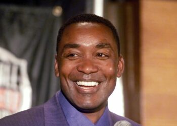 Former Detroit Pistons guard Isiah Thomas smiles as he meets the media at the Palace in Auburn Hills, Michigan, after being named to the Naismith Memorial Basketball Hall of Fame on Wednesday, May 24, 2000. Photo credit: Carlos Osorio, The Associated Press