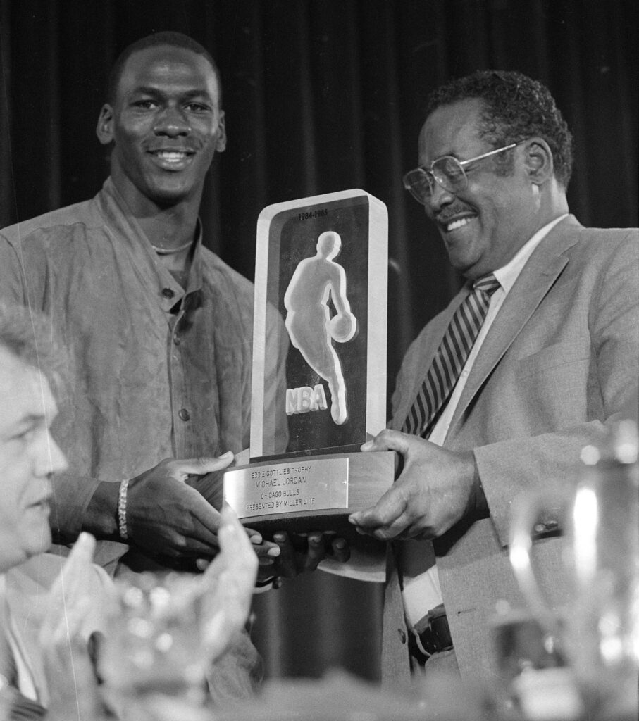 The Chicago Bulls' Michael Jordan, left, receives the NBA's Rookie of the Year trophy from an unidentified NBA official during the NBA award ceremony in San Francisco, June 24, 1985.  Photo credit: Paul Sakuma, The Associated Press
