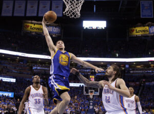 Golden State Warriors guard Klay Thompson (11) shoots over Oklahoma City Thunder center Steven Adams (12) during the second half in Game 6 of the NBA basketball Western Conference finals in Oklahoma City, Oklahoma, on Saturday, May 28, 2016. The Warriors won 108-101. Photo credit: Sue Ogrocki, The Associated Press
