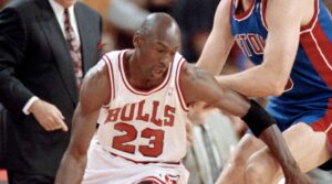 The Chicago Bulls' Michael Jordan (then number 23) moves around the Detroit Pistons' Bill Laimbeer (40) during the first quarter of their playoff game in Chicago, May 21, 1991. Pistons coach Chuck Daly watches in the background. Photo credit: John Swart, The Associated Press