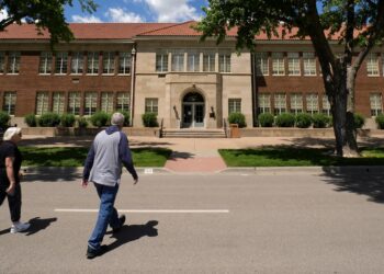 Visitors walk to the former Monroe School, which now houses a national historic site, Friday, May 10, 2024, in Topeka, Kansas. The school was at the center of the Brown v. Board of Education Supreme Court ruling ending segregation in public schools 70 years ago. Photo credit: Charlie Riedel, The Associated Press