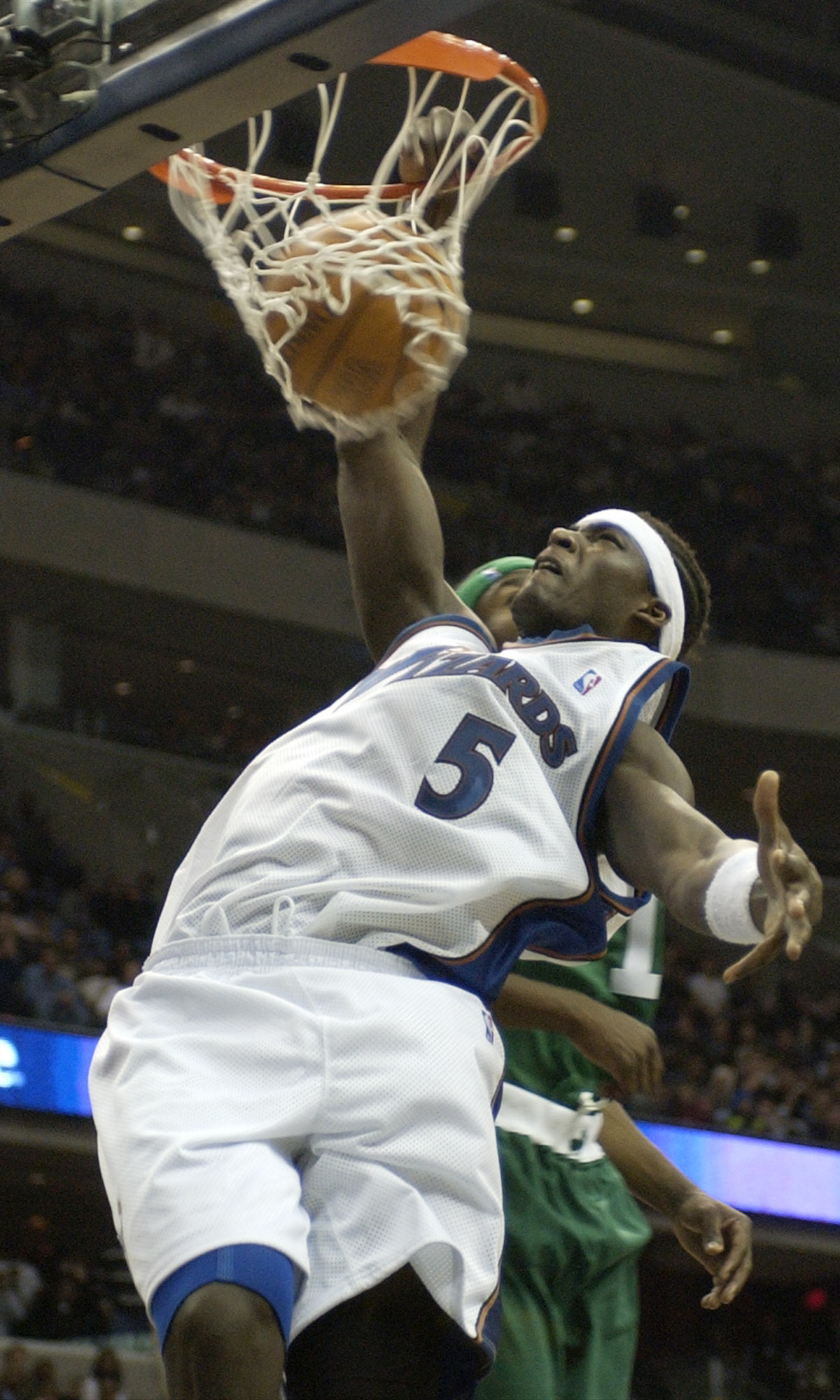Then Washington Wizard Kwame Brown (5) dunks against the Boston Celtics during the fourth quarter of the Wizards 114-69 win, Thursday, Oct. 31, 2002, at the MCI Center in Washington. Photo credit: Nick Wass, The Associated Press