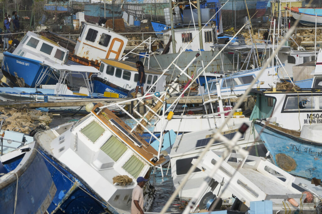 A fisherman looks at fishing vessels damaged by Hurricane Beryl at the Bridgetown Fisheries in Barbados on Monday, July 1, 2024. Photo credit: Ricardo Mazalan, The Associated Press