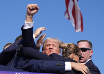 Republican presidential candidate and former President Donald Trump is surrounded by U.S. Secret Service agents at a campaign rally on Saturday, July 13, 2024, in Butler, Pennsulvania. Photo credit: Evan Vucci, The Associated Press