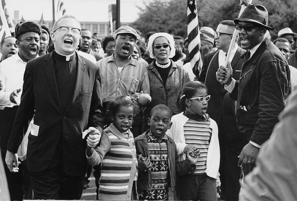 Dr. Ralph David Abernathy, a central figure in the civil rights movement, and his wife, Juanita Abernathy, follow with Dr. and Mrs. Martin Luther King as the Abernathy children march on the front line of the Selma-to-Montgomery March in Alabama in 1965. Photo courtesy Abernathy Family via Wikimedia