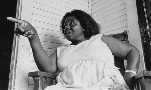 Fannie Lou Hamer sitting on a porch in the summer of 1964. Photo courtesy the University of Southern Mississippi
