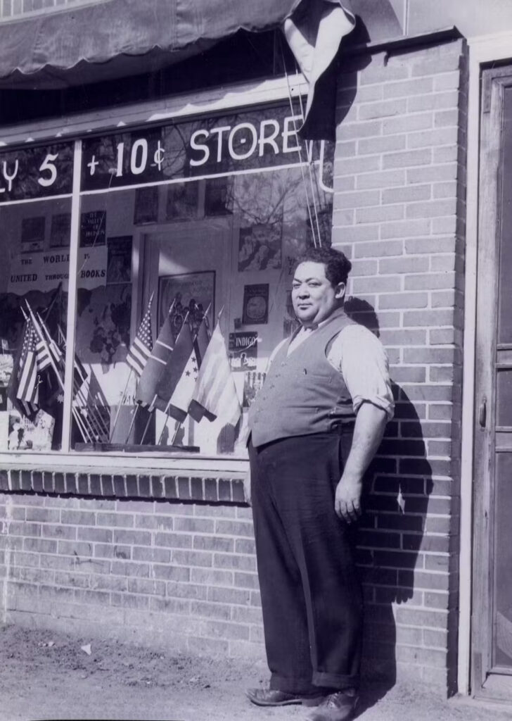 George Elmore stands in front of the Waverly 5 and 10 Cents store in Waverly, South Carolina, in 1945. Photo is in the public domain.