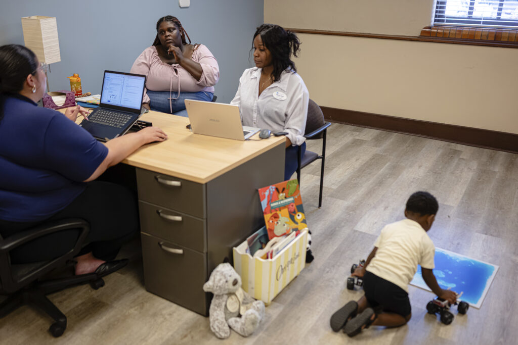Aaliyah Barnes, center, meets with family advocates Brittany Jackson, left, and Tiara Scott, right, at the Stoddard Johnston Scholar House, on Friday, July 11, 2025, in Louisville, Kentucky. Photo credit: Jon Cherry, The Associated Press