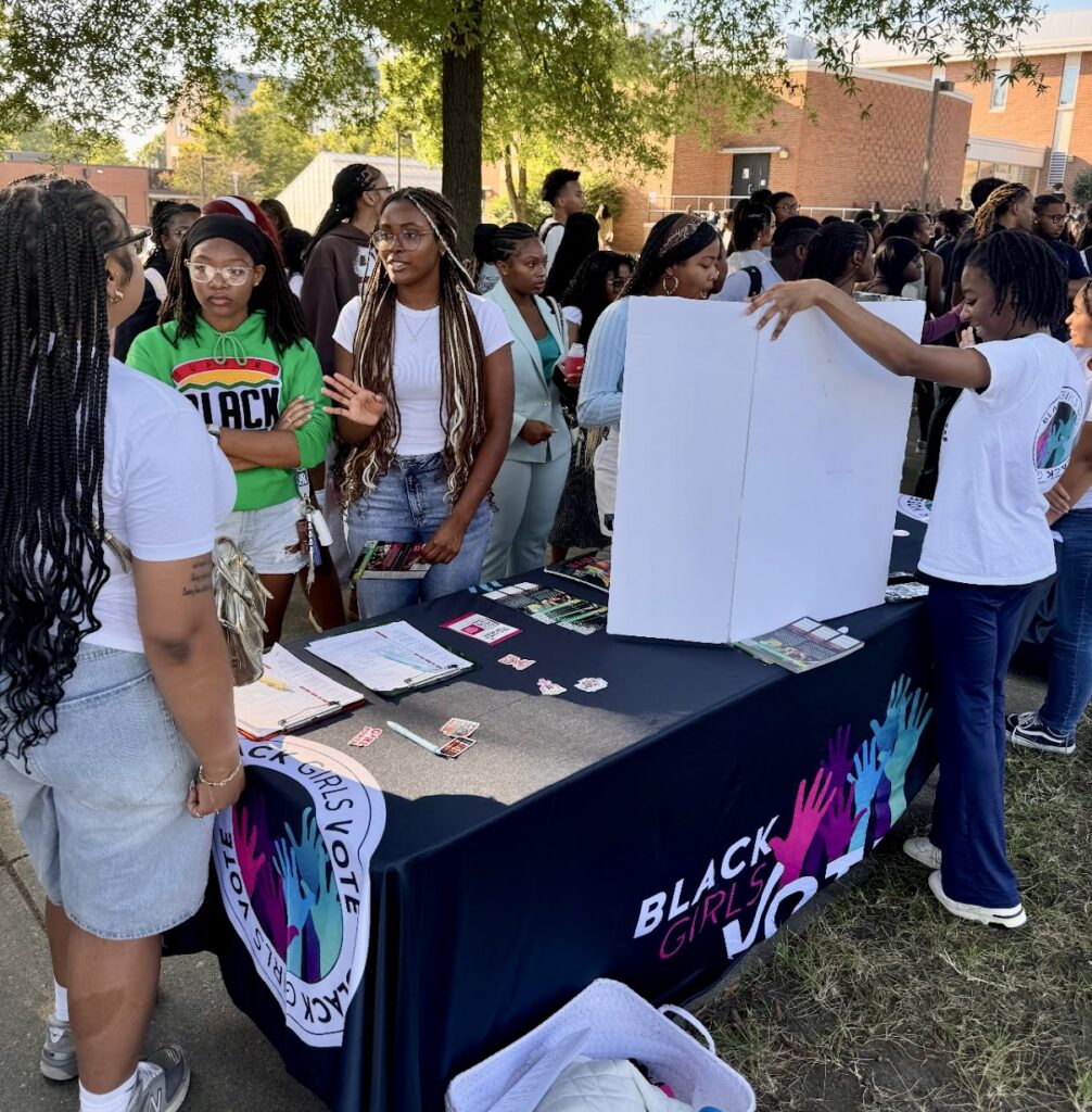 Ryann Dawkins, center, white shirt, behind the desk, president of the Black Girls Vote chapter at North Carolina A&T University in Greensboro, North Carolina, registers students to vote. Photo courtesy Ryann Dawkins.