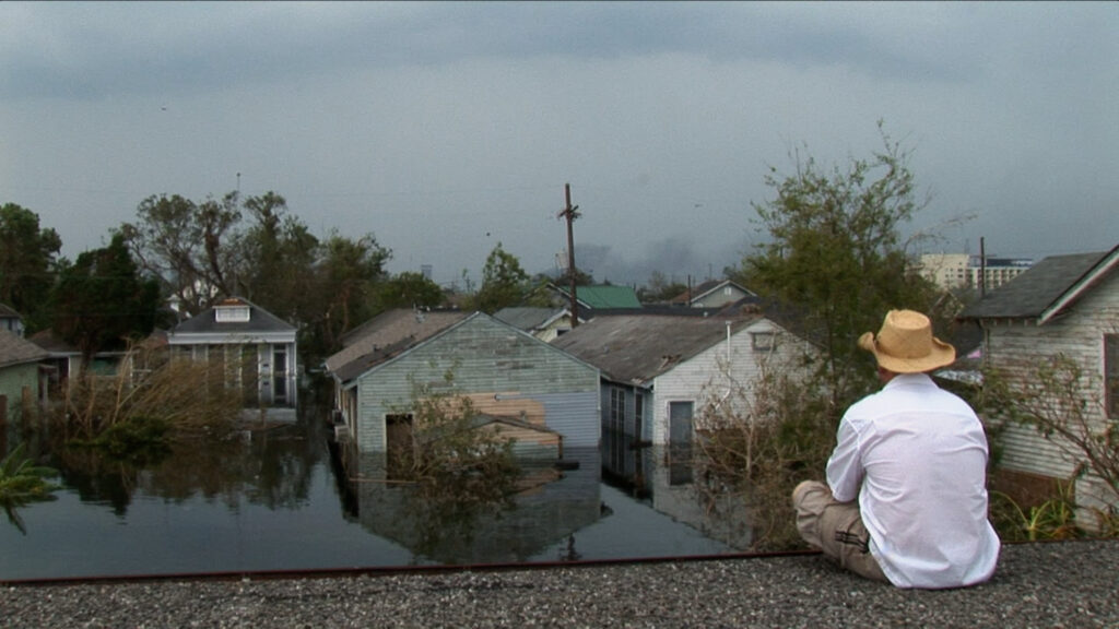A man is stranded on a rooftop in the aftermath of Hurricane Katrina in 2005, as shown in the NatGeo documentary "Hurricane Katrina: Race Against Time." Photo credit: Wickes Helmboldt