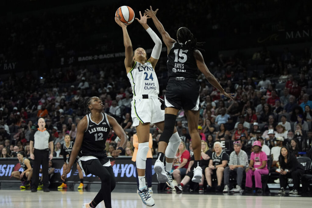 Minnesota Lynx forward Napheesa Collier (24) shoots against Las Vegas Aces guard Tiffany Hayes (15) during a WNBA basketball game on Aug. 21, 2024, in Las Vegas. Photo credit: John Locher, The Associated Press