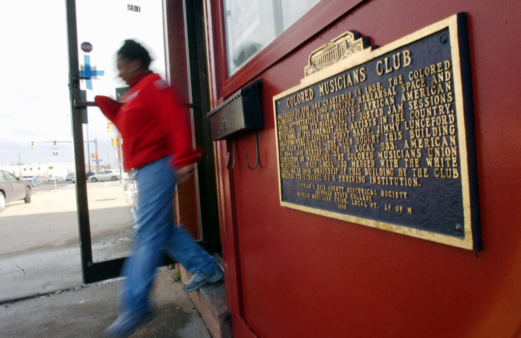 Shawntay Howie of AmeriCorps exits the Colored Musicians Club & Jazz Museum in Buffalo after working on a renovation project on Jan. Jan. 14, 2005. Photo credit: David Duprey, The Associated Press