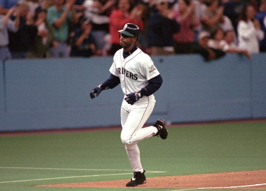 Seattle Mariners' Ken Griffey Jr. gets a standing ovation as he passes third base on his first-inning home run against the Toronto Blue Jays Monday, Sept. 15, 1997 in Seattle. Photo credit: Elaine Thompson, The Associated Press