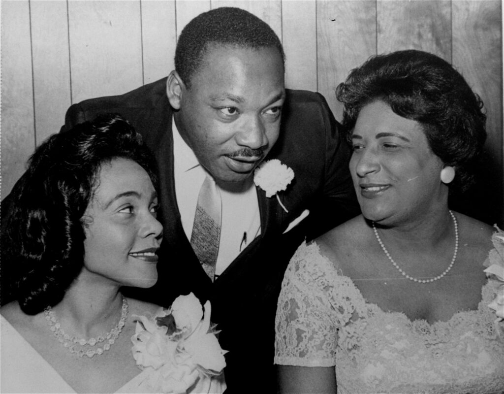 In this Aug. 9, 1965, file photo, the late Dr. Martin Luther King Jr., then president of the Southern Christian Leadership Conference, chats with his wife, Coretta, left, and civil rights champion Constance Baker Motley before the start of an S.C.L.C. banquet in Birmingham, Alabama. Photo credit: The Associated Press