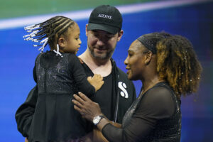 Serena Williams talks with her daughter, Olympia, and husband, Alexis Ohanian, after defeating Danka Kovinic, of Montenegro, during the the U.S. Open tennis championships on Aug. 29, 2022, in New York. Photo credit: Charles Krupa, The Associated Press