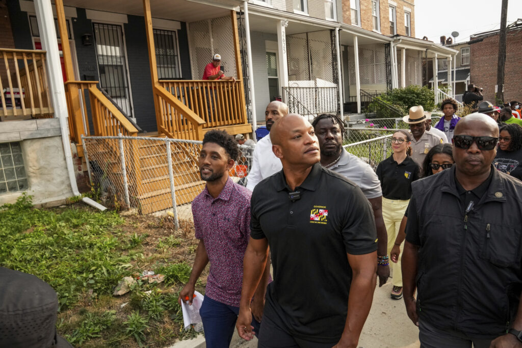Maryland Gov. Wes Moore, center right, and Baltimore Mayor Brandon Scott, center left, lead a community walk in northwest Baltimore, on Friday, Sept. 5, 2025. Photo credit: Ulysses Muñoz, The Baltimore Banner via The Associated Press, pool