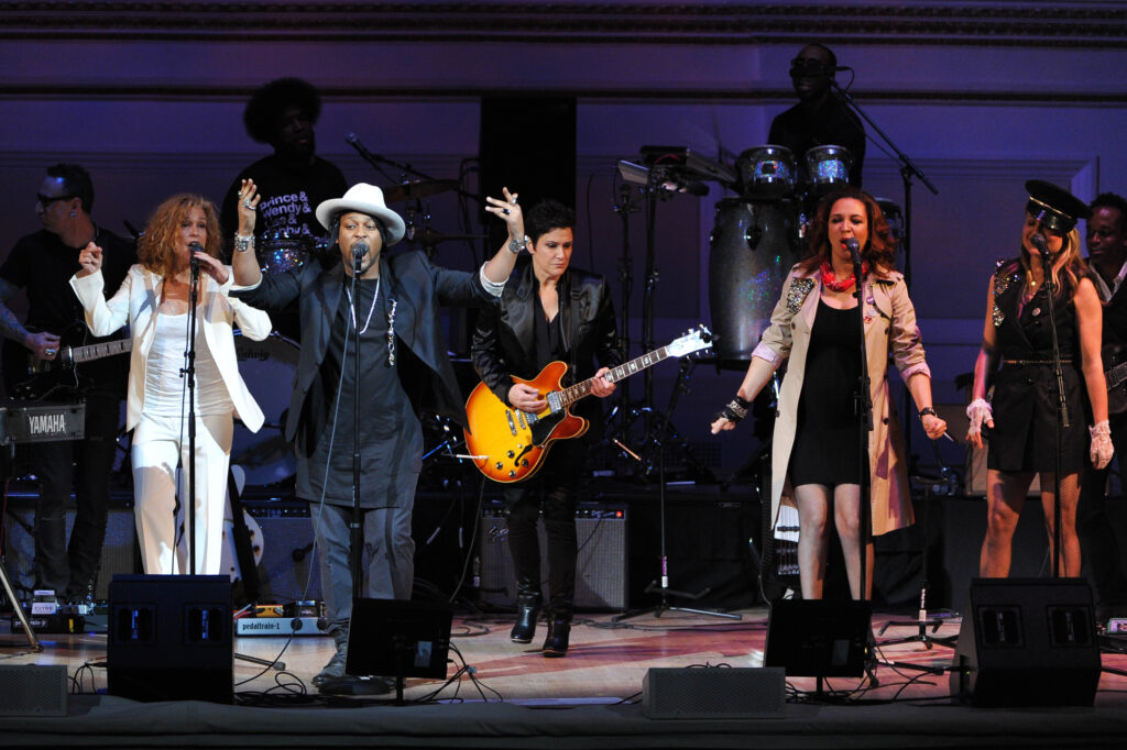 Singer D'Angelo, left, performs with Wendy Melvoin, Maya Rudolph, and Gretchen Lieberum at "The Music of Prince" tribute concert at Carnegie Hall on Thursday March 7, 2013, in New York. Photo byEvan Agostini, Invision/The Associated Press