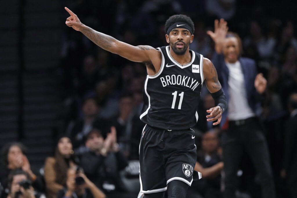 Brooklyn Nets guard Kyrie Irving (11) celebrates after scoring during the first half of the team's NBA basketball game against the Minnesota Timberwolves on Oct. 23, 2019, in New York. Irving had 50 points but the Nets fell to the Timberwolves in overtime, 127-126. Photo credit: Kathy Willens, The Associated Press