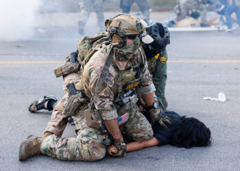 Federal officers hold down a protester in the Brighton Park neighborhood of Chicago on Saturday, Oct. 4, 2025, after protesters learned that U.S. Border Patrol shot a woman Saturday morning on Chicago's Southwest Side. Photo credit: Anthony Vazquez, Chicago Sun-Times via The Associated Press