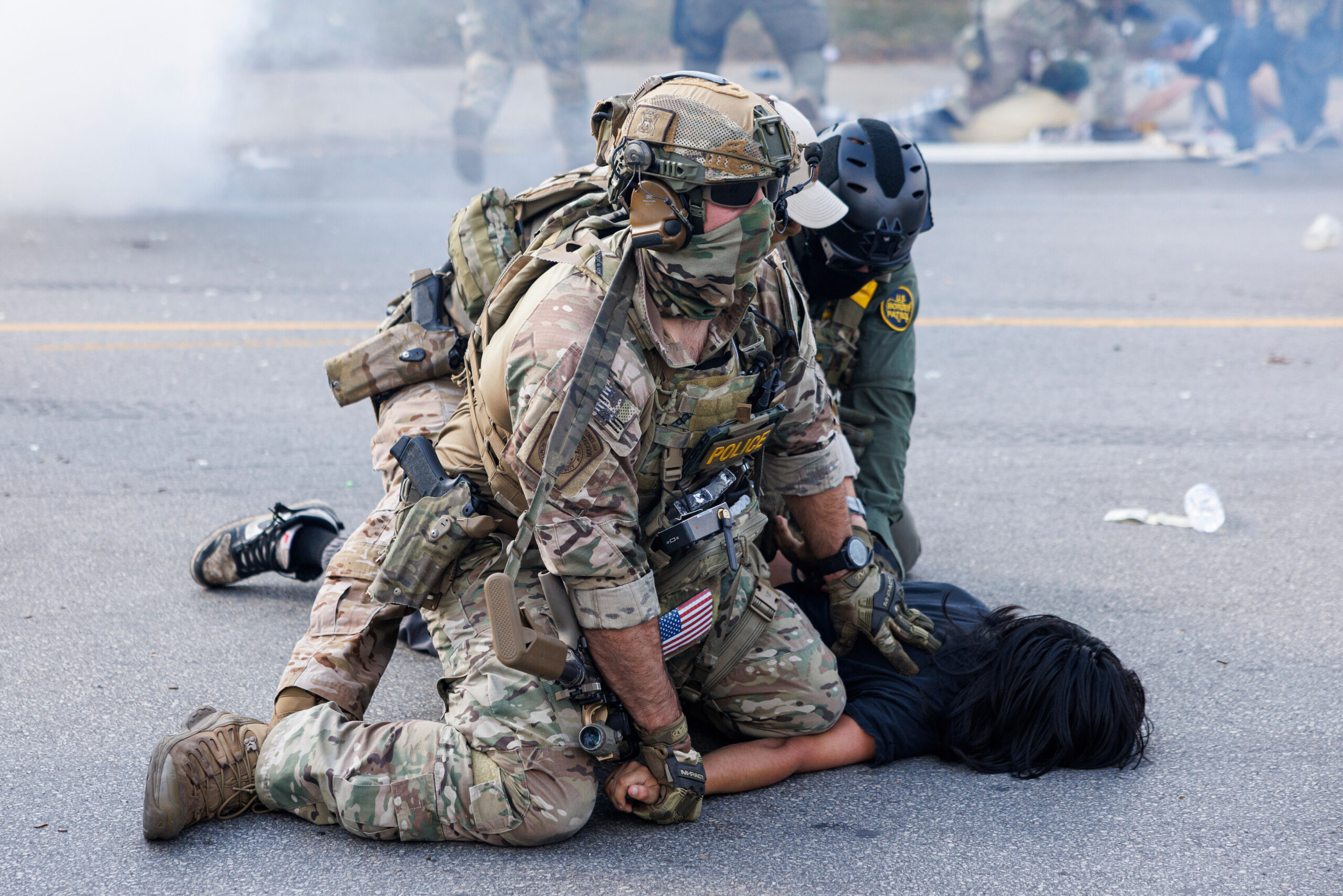 Federal officers hold down a protester in the Brighton Park neighborhood of Chicago on Saturday, Oct. 4, 2025, after protesters learned that U.S. Border Patrol shot a woman Saturday morning on Chicago's Southwest Side. Photo credit: Anthony Vazquez, Chicago Sun-Times via The Associated Press